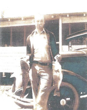 Glenn in Front of the Cabin About 1932